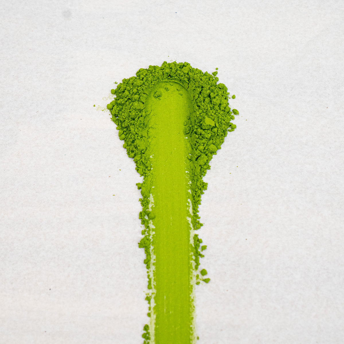 Organic Japanese Green tea matcha powder in a pile on a white background